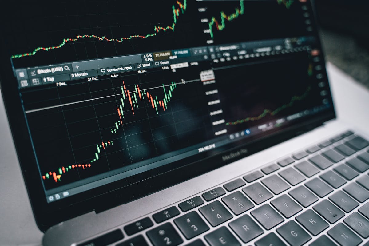 Laptop showing financial trading charts and analysis